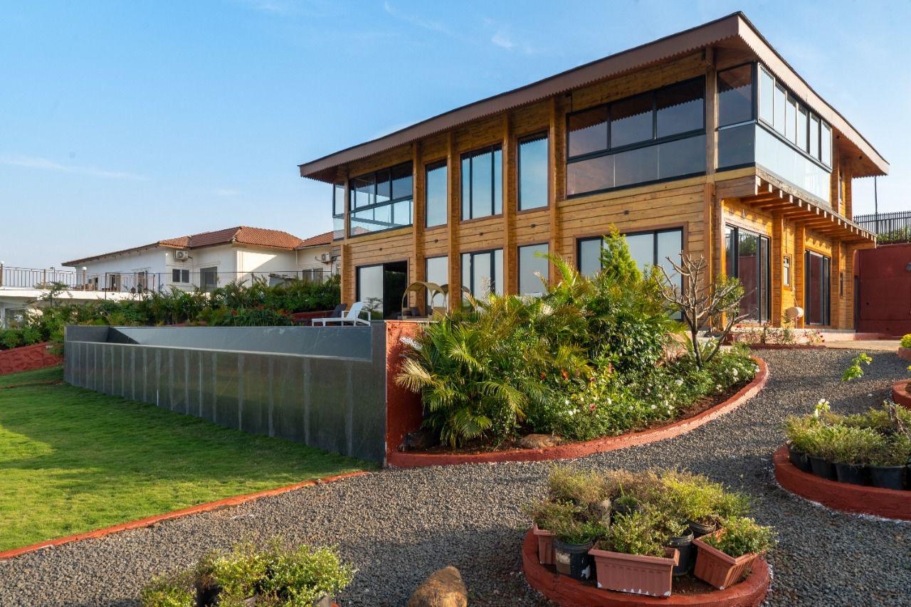 A luxury villa at twilight overlooking Pawna Dam